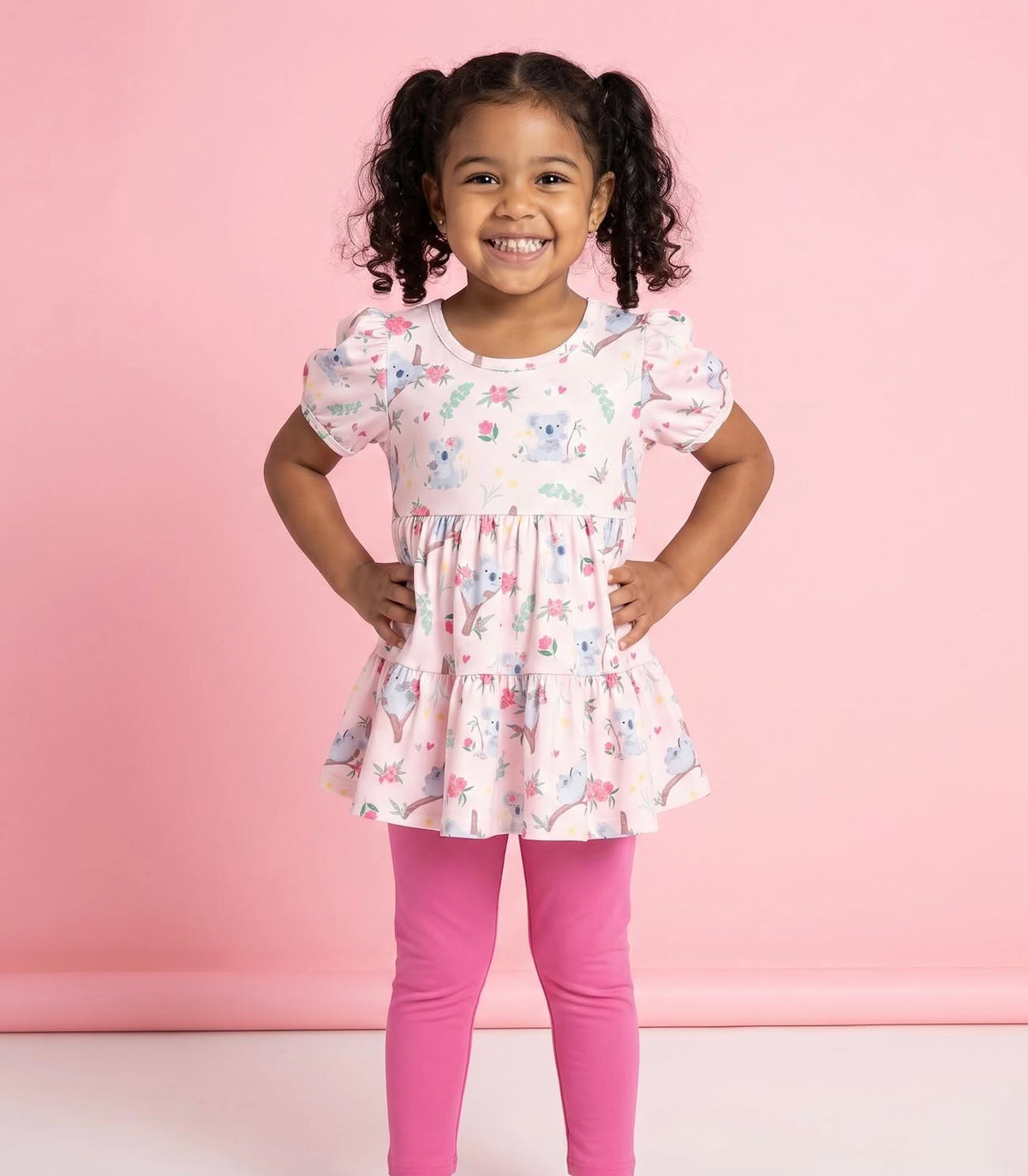 Child modeling the Koala Cuddles tiered koala-print top and pink pants.