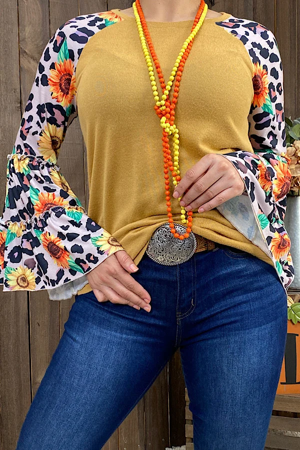 Women's golden ginger top with sunflower and leopard-print sleeves and flared bell cuffs.