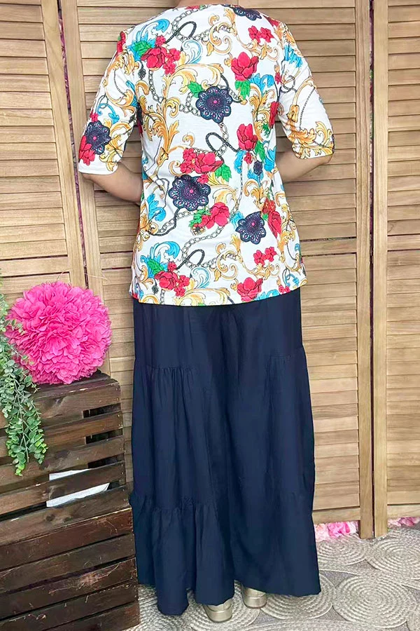 Back view of women's multicolor paisley and floral half-sleeve top.