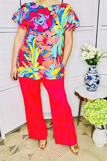 Front detail of floral flutter-sleeve shirt and red pants
