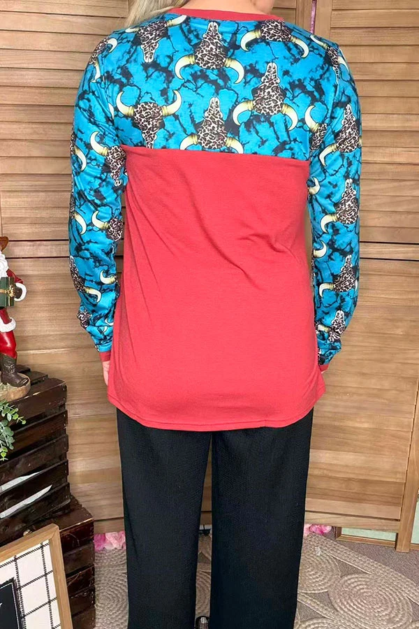 Back of women's color-block top with rust red body and turquoise leopard bull-head print shoulders and sleeves.