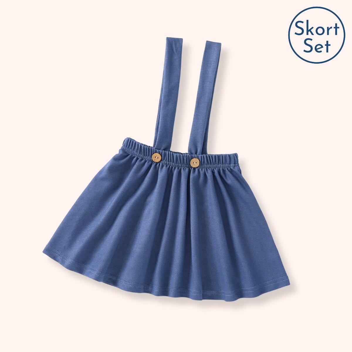 Blue Winter Overall Skort with overall straps, gathered waistband, and two tan front buttons.