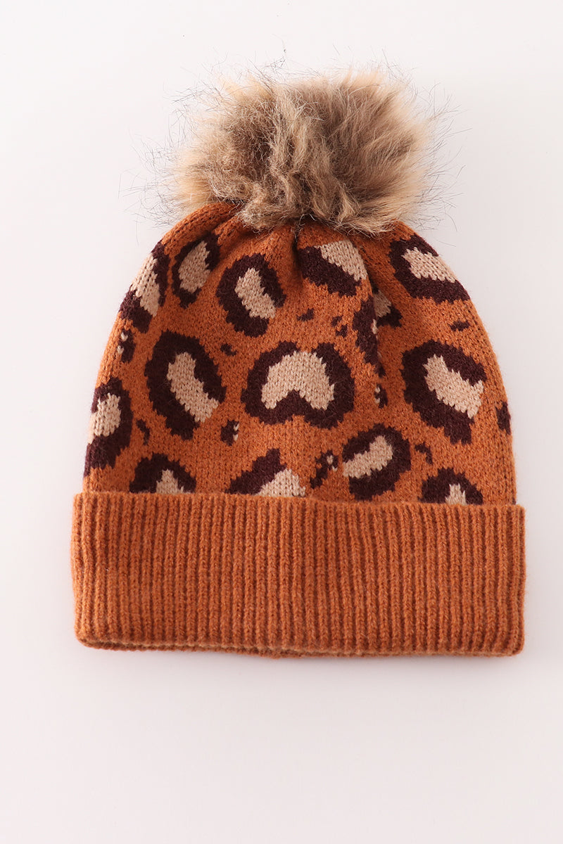 Brown leopard-pattern knit beanie with a fluffy pompom