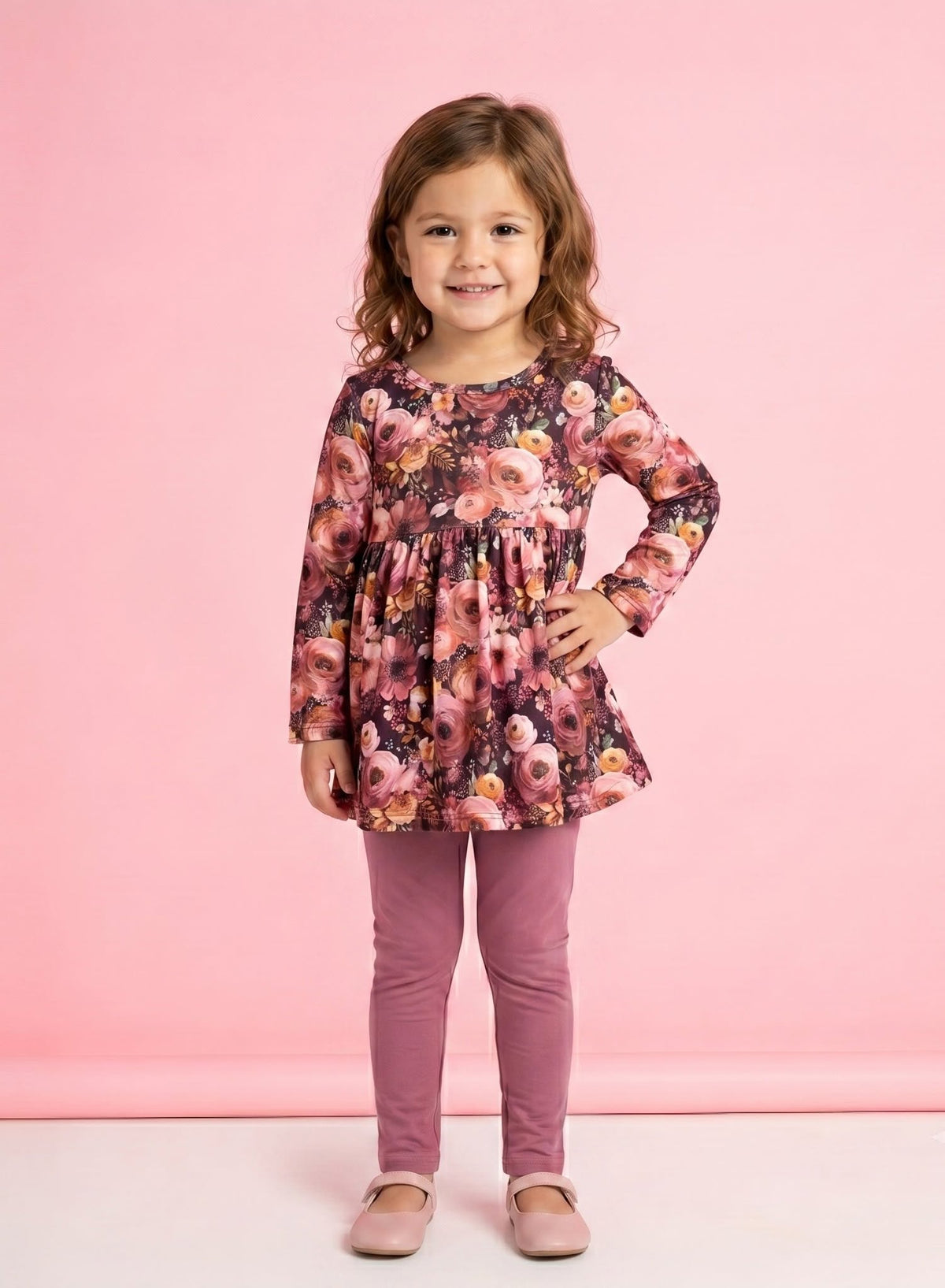 Child wearing the Autumn Embers floral dress and mauve leggings set