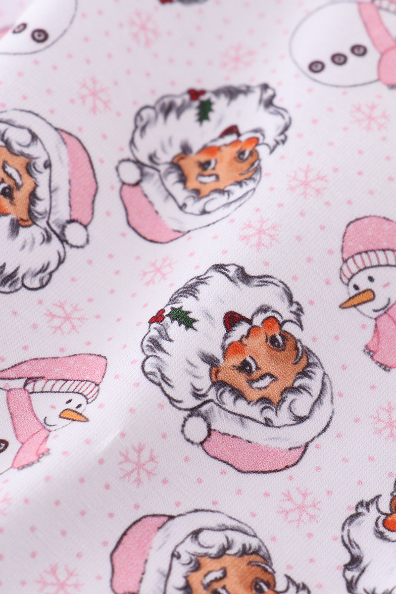 Close-up of the pink fabric with Santa Claus and snowman motifs