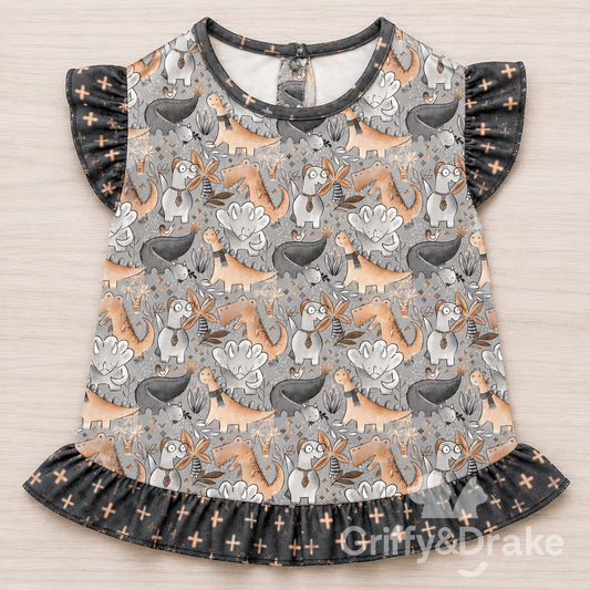 Jurassic Tails Ruffle Shirt by Griffy & Drake - whimsical dinosaur print with dark ruffle trim