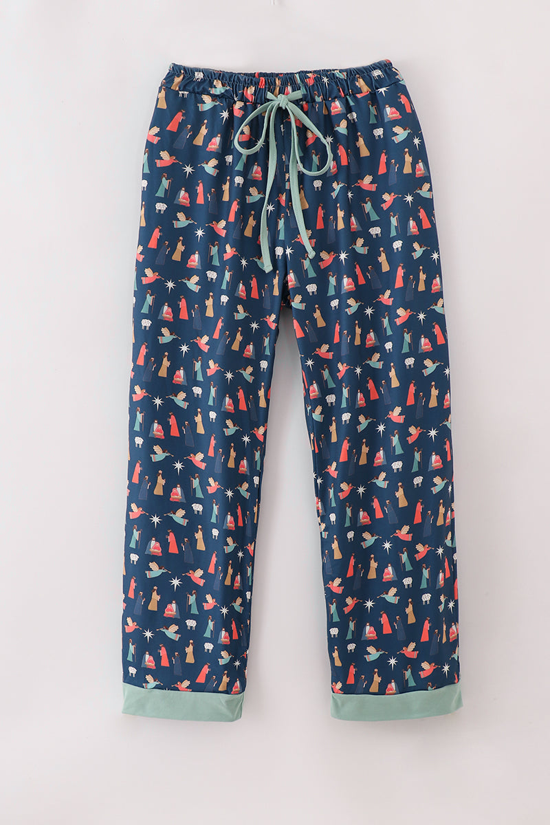 Full-length navy men's pajama pants with a colorful Nativity print and mint-green cuffs