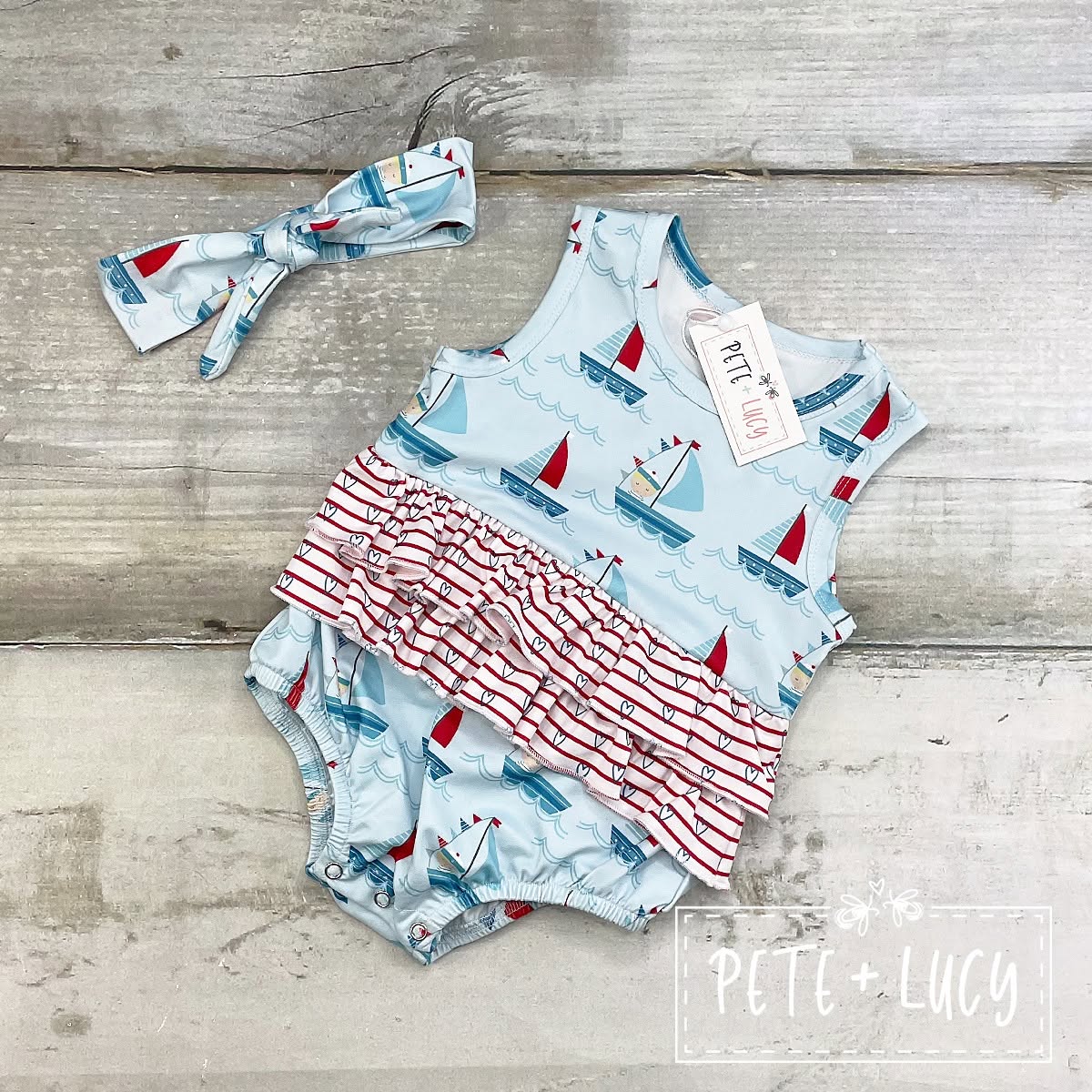 Pete + Lucy Ahoy Matey infant romper with sailboats and striped ruffle