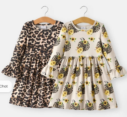 Front view of both autumn dresses: leopard print and leopard-print pumpkins with yellow sunflowers.