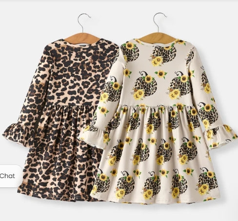 Back view of both long-sleeve autumn dresses with ruffled cuffs.
