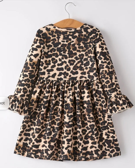 Back of all-over leopard-print girls dress with gathered skirt and ruffled cuffs.