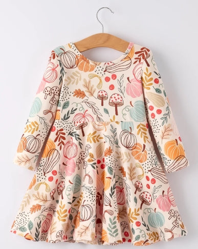 Front of long-sleeve girls dress with pastel pumpkins, leaves, mushrooms, and berries on a light background.