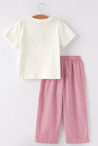 Back view of cream boys shirt and red-and-white striped pants