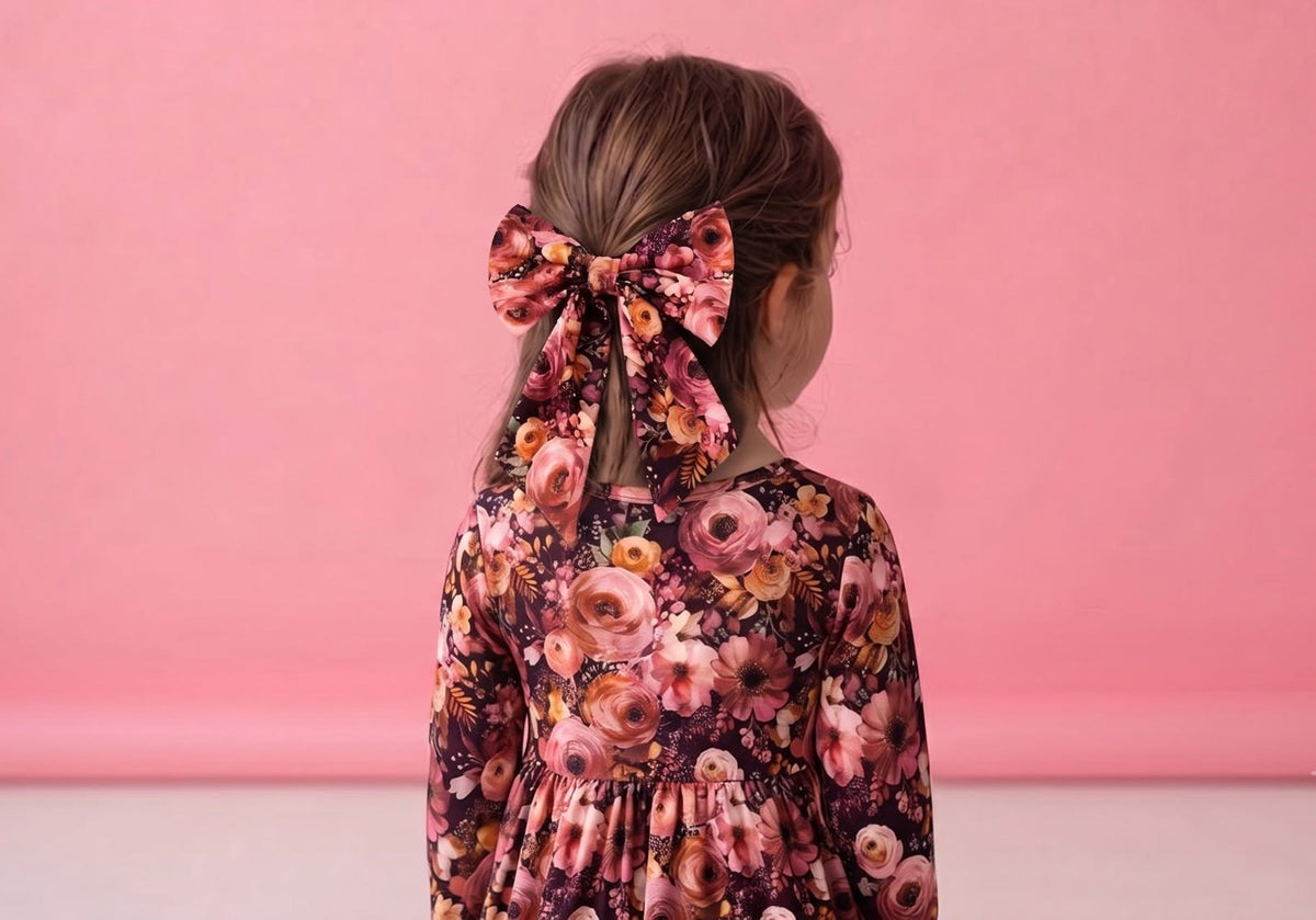 Child wearing the Autumn Embers floral bow hair accessory