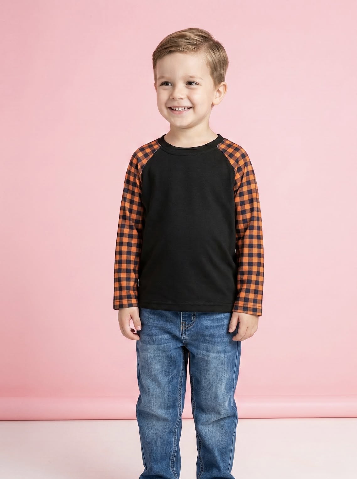 Child wearing the black Harvest Gingham shirt with orange-and-black sleeves