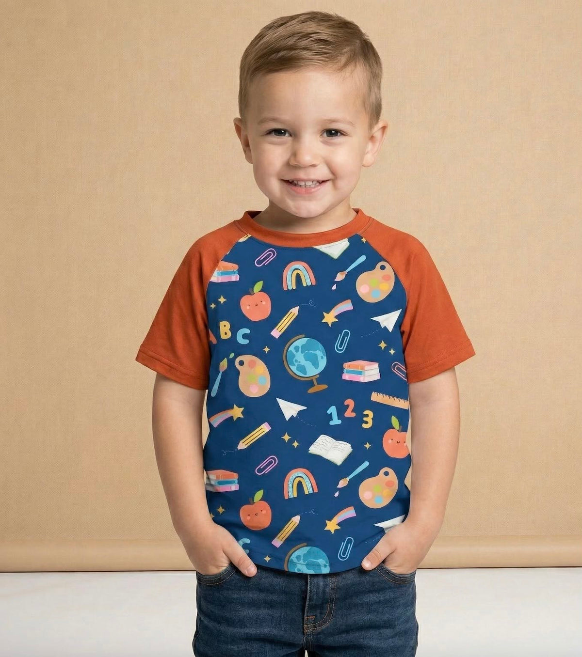 Child modeling the Little Learners navy and rust-orange school-print shirt.