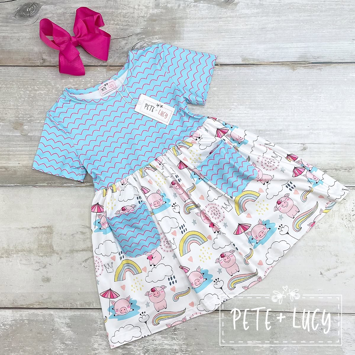 Pete + Lucy Piggy Party dress with blue top and pig-and-rainbow print skirt