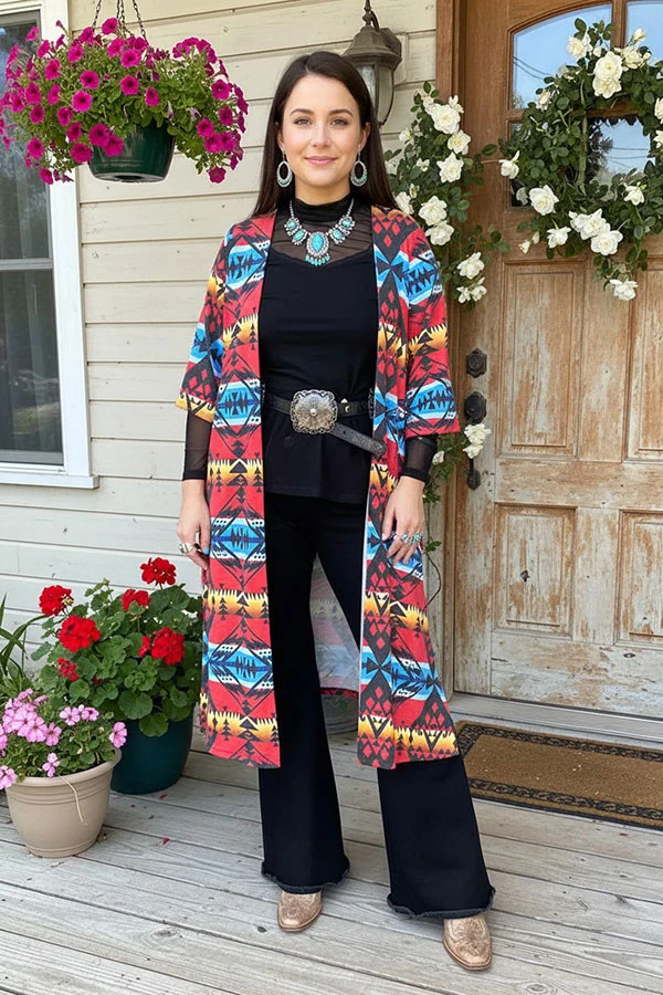 Woman modeling a longline multicolor Aztec print open-front cardigan over a black outfit.