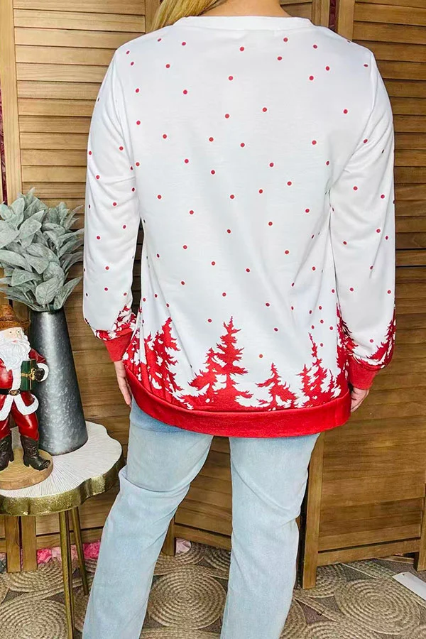 Back of women's Christmas blouse with scattered red dots, red trees, and red hem band.
