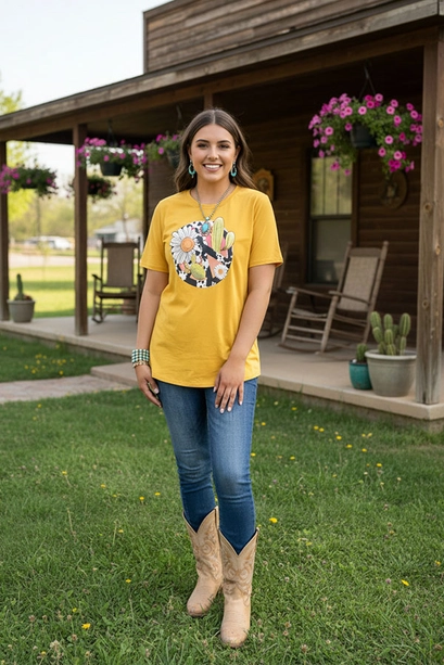 Mustard yellow Western peace graphic T-shirt styled with jeans and boots