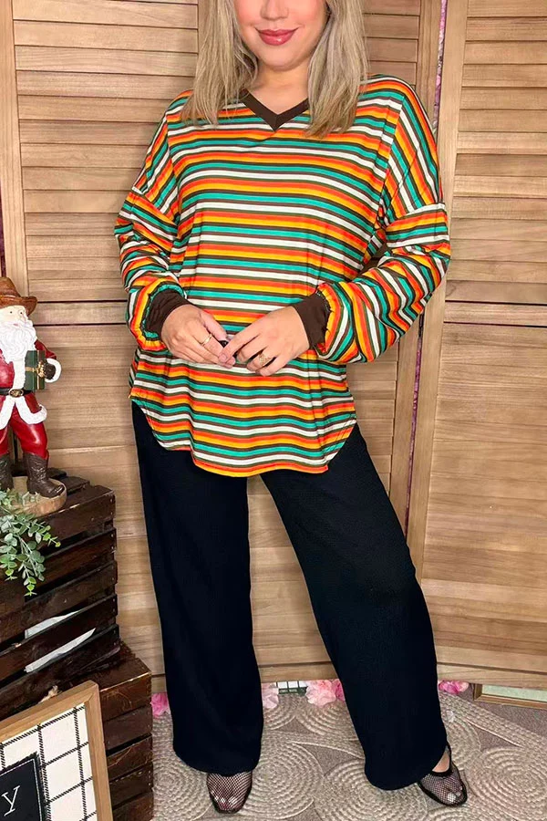 Front view of women's multicolor striped top with contrasting dark cuffs and curved hem.