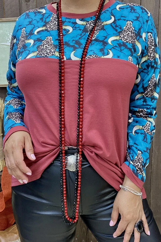 Front of women's rust red top with turquoise leopard bull-head print upper panel and long sleeves.