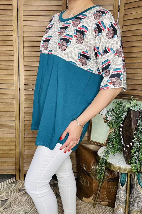 Side view of teal women's top with pale leopard print upper panel and colorful mouth graphics