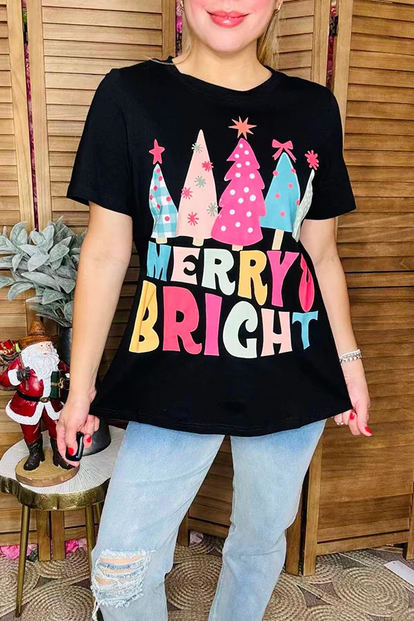 Close-up of colorful Christmas trees and MERRY BRIGHT lettering on black T-shirt