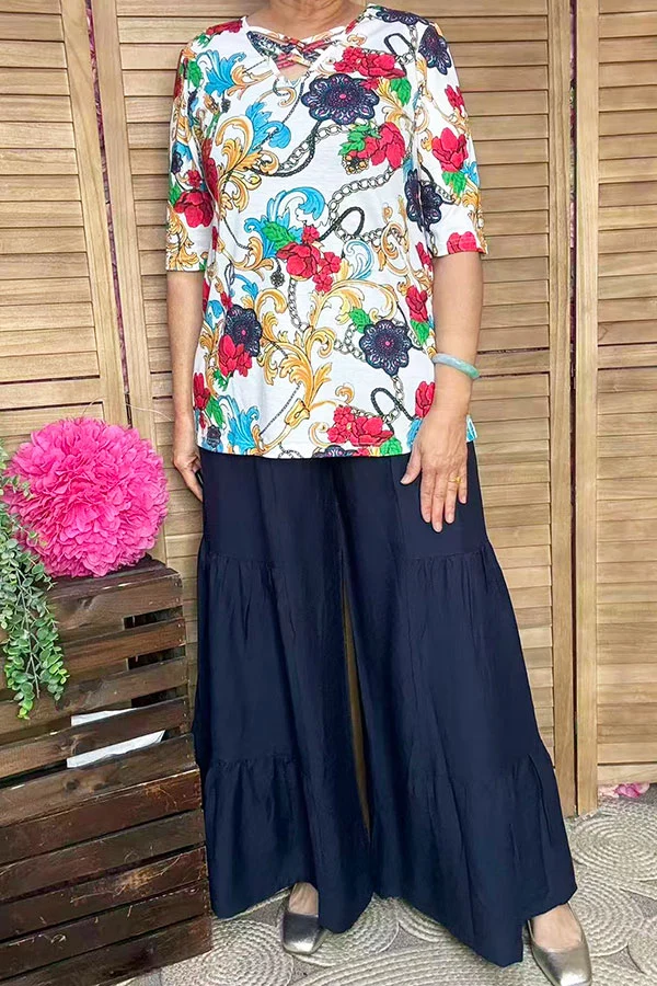Front view of women's paisley and floral top showing crossed neckline detail and half sleeves.