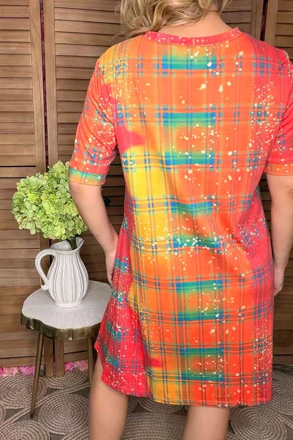 Back view of orange yellow coral and teal checked print dress