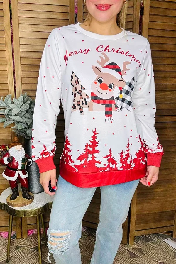 Front detail of Merry Christmas blouse with plaid reindeer, patterned trees, and red cuffs.