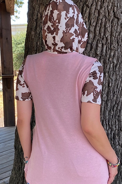 Back view of pink hooded top with cow-print hood and short sleeves