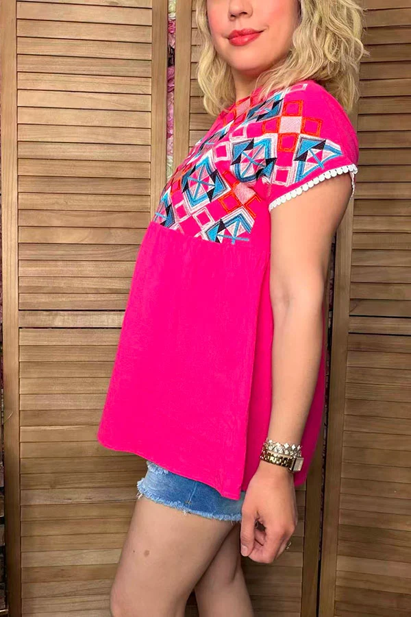 Side view of hot pink women's short-sleeve top with gathered lower panel.