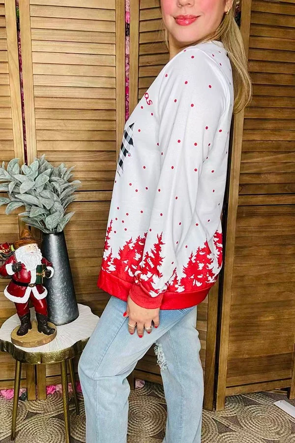 Side view of women's Christmas blouse with red dots and red tree border.
