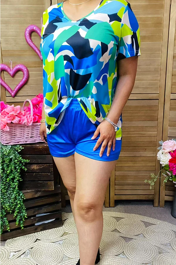 Close-up front view of multicolor abstract V-neck top and blue shorts