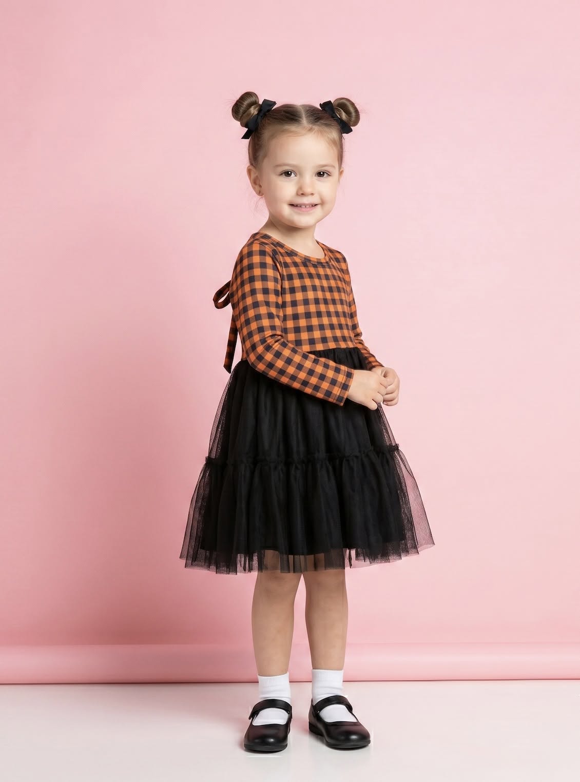 Child wearing the orange-and-black Harvest Gingham Tulle Dress
