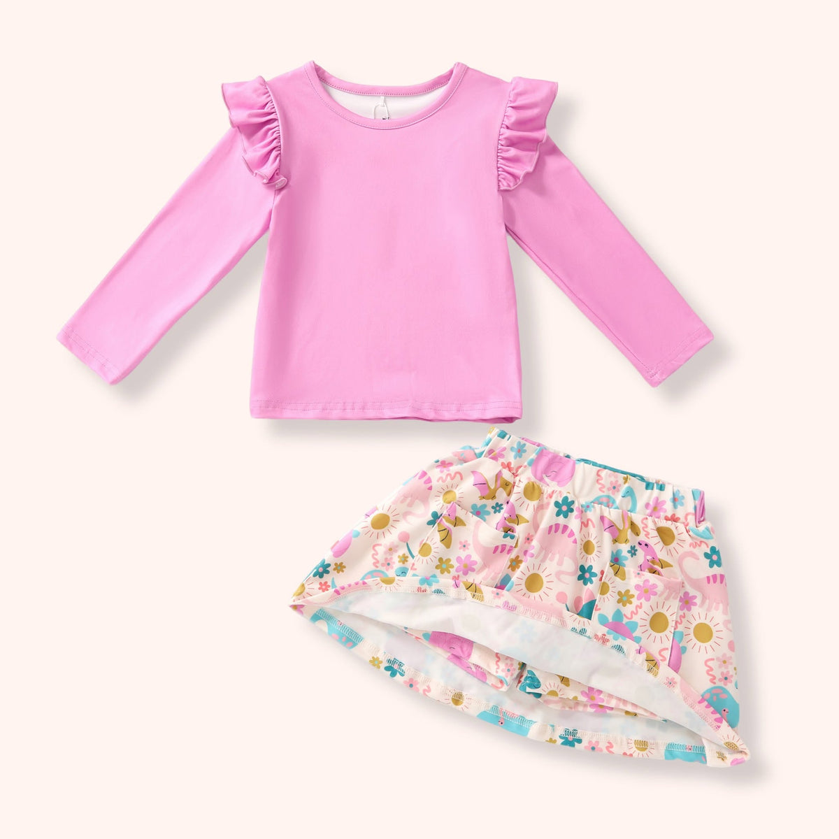 Close-up of the Jurassic Dreams pink top and dinosaur-print skort