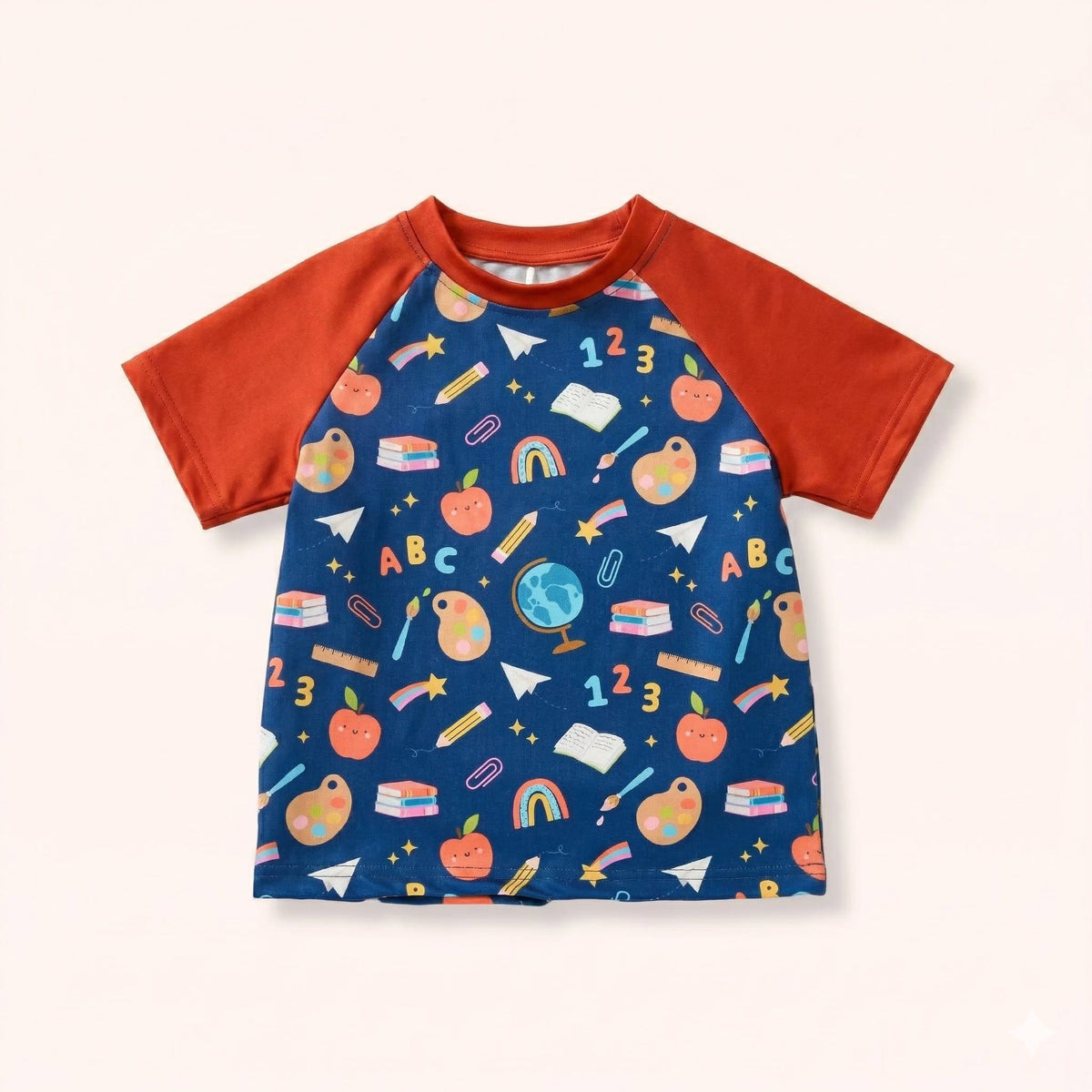 Little Learners boy shirt with navy school-themed print and rust-orange short raglan sleeves.